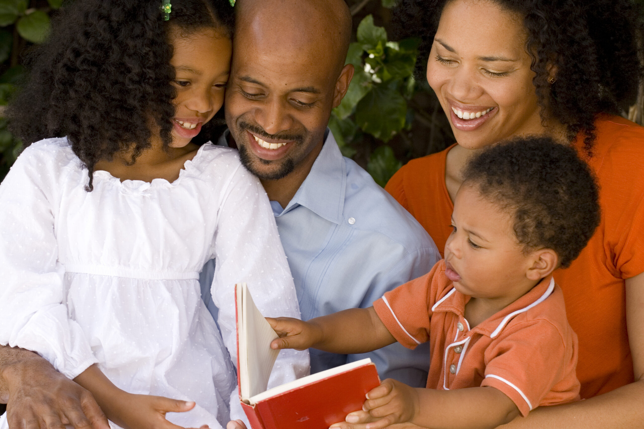 Happy African American parents and their children.