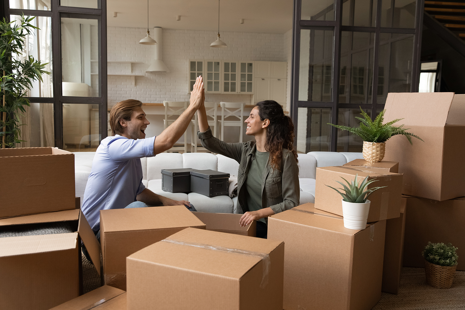 Joyful family couple apartment renters buyers celebrate starting independent life