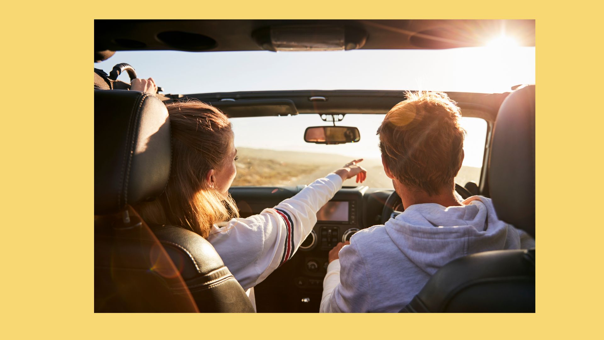 Couple driving a convertible on a sunny day